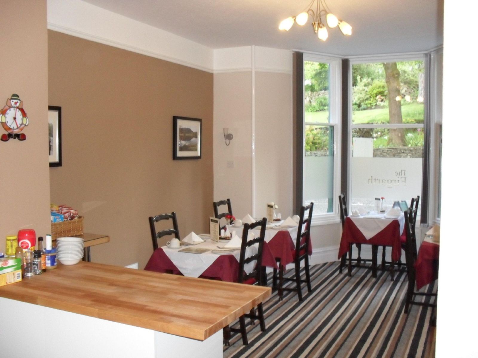 The breakfast room set with red and white tablecloths